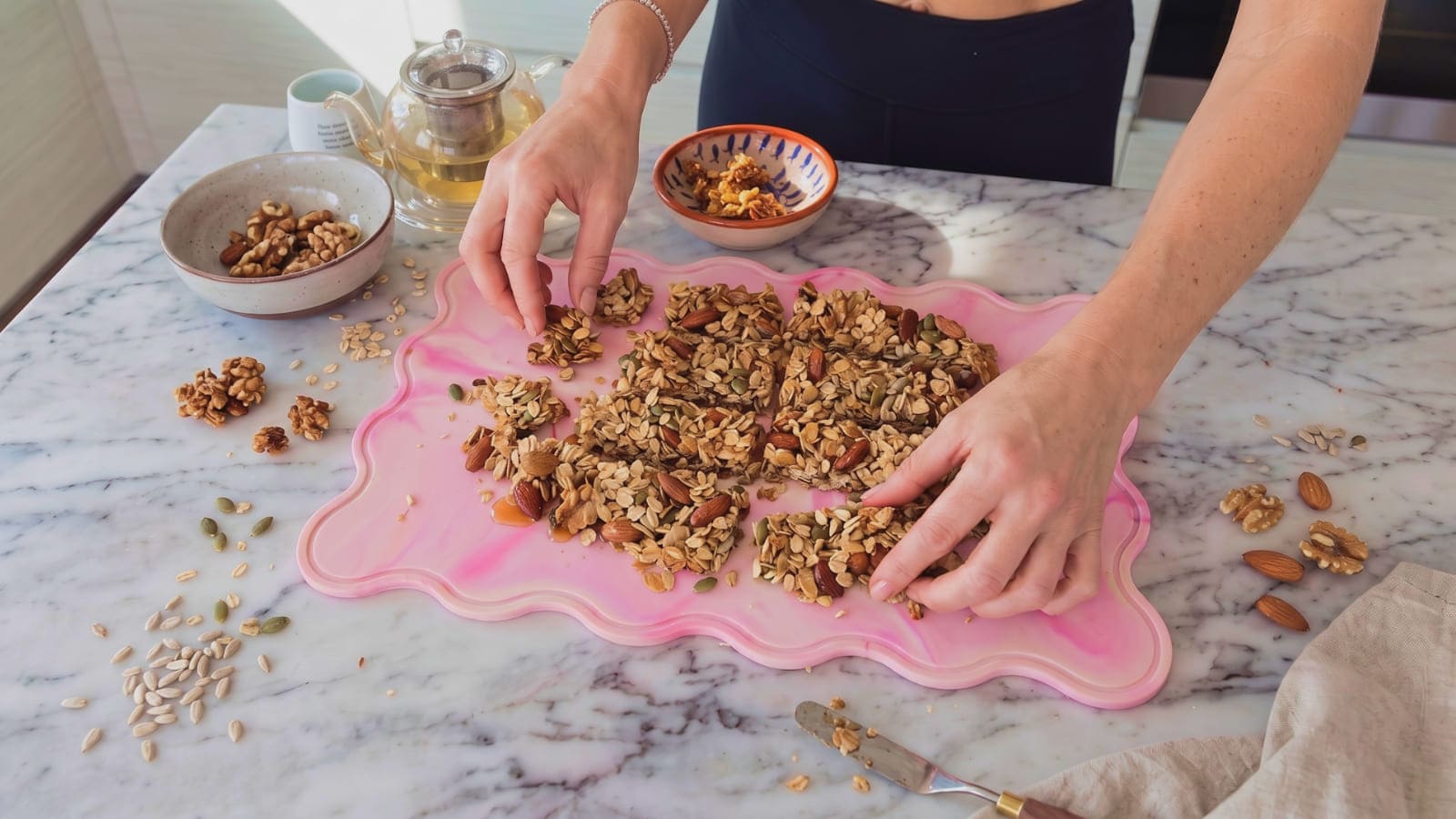 Homemade granola in chunky clusters on a STYLD.Chop silicone board